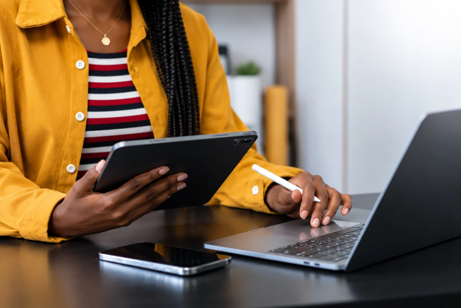 Femme travaillant sur un ordinateur portable et une tablette